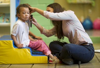 Médecin auscultant l'oreille d'une enfant